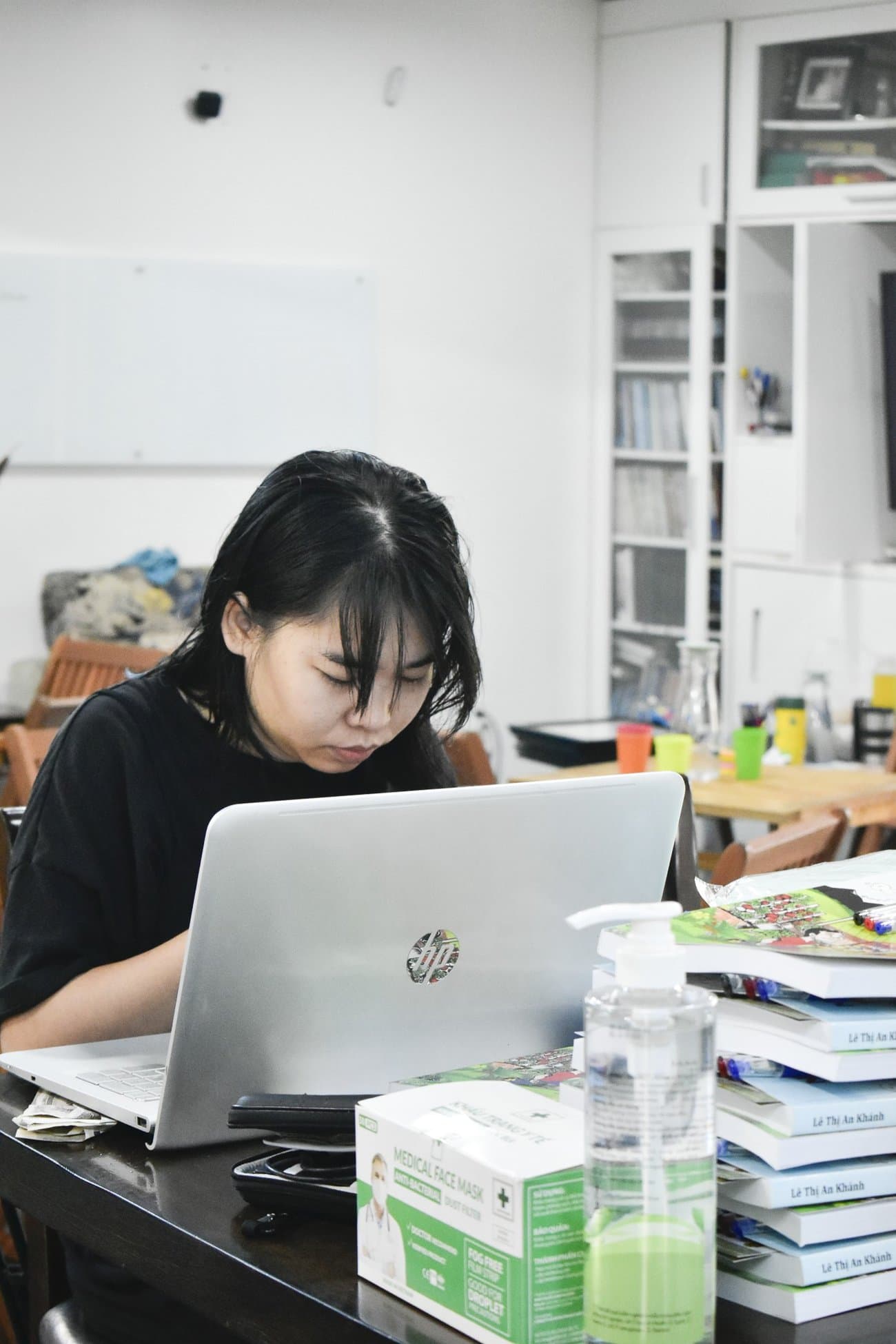 A team member working on a laptop at a table